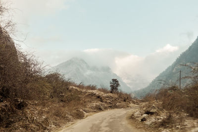 Road amidst mountains against sky