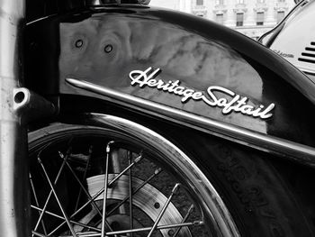 Close-up of bicycle sign on street in city