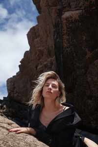 Young woman sitting on rock