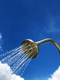 Low angle view of shower against blue sky