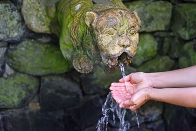 Close-up of human hand holding fountain