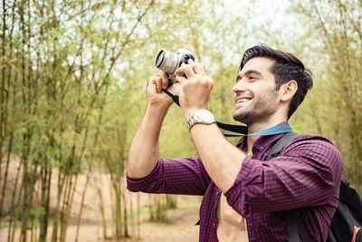 Full length of man looking at forest