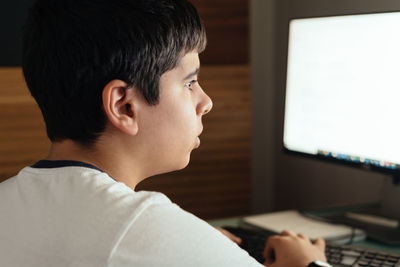 Portrait of boy looking at camera at home