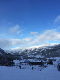 Scenic view of snowcapped mountains against blue sky