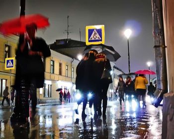 Blurred motion of woman in city at night
