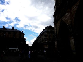 Low angle view of building against cloudy sky