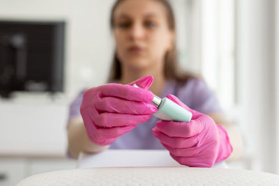 Close-up of woman holding dentures