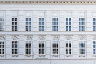 Array of windows if old neoclassical style palace in vienna