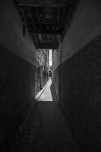 Empty narrow alley along buildings