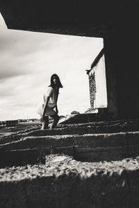 Side view of man standing against wall