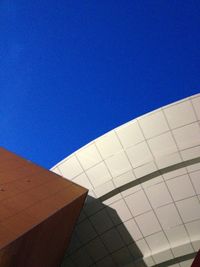 Low angle view of building against clear blue sky