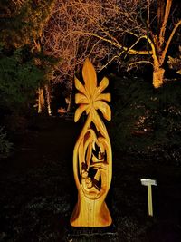 Illuminated sculpture in park during night