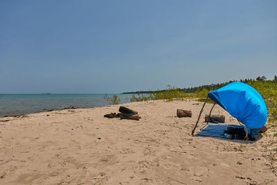 Scenic view of beach against clear blue sky