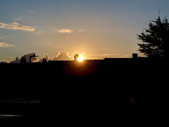 Silhouette buildings against sky during sunset