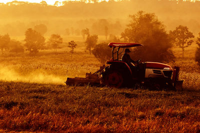 Tractor on field against sky