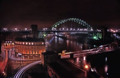 Suspension bridge over river at night