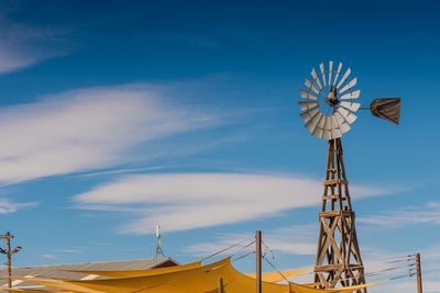 Low angle view of traditional windmill against sky