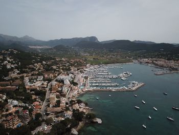 High angle view of townscape by sea against sky