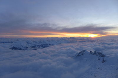 Scenic view of snow mountains against sky during sunset