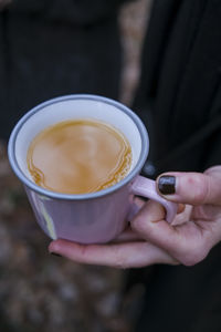 Midsection of man holding mulled wine