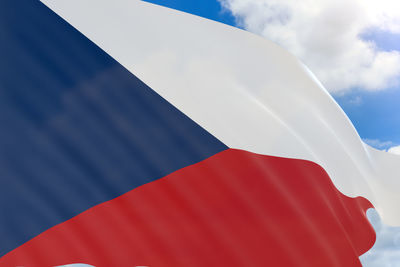 Low angle view of flag against blue sky