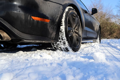 Close-up of car on snow covered land