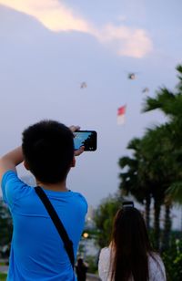 Rear view of woman photographing