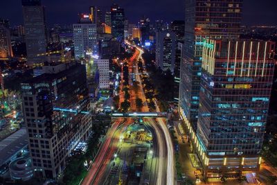 Illuminated city street at night