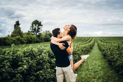 Full length of couple standing on field