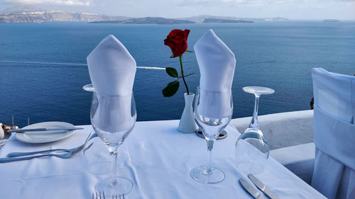 White rose on table by sea