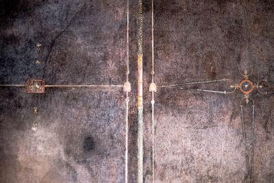 Full frame shot of rusty metal hanging on wood