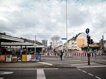 Buildings in city against cloudy sky