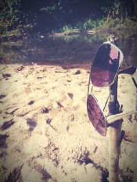 Close-up of sunglasses on beach