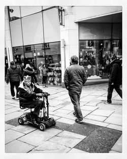 People walking on sidewalk in city