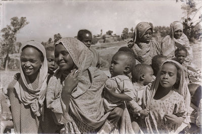 Portrait of a smiling girl with people in background