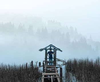 Traditional windmill on field against sky