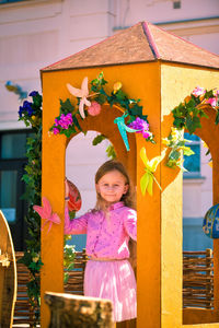 Portrait of girl playing with christmas tree