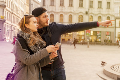 Young couple standing in city