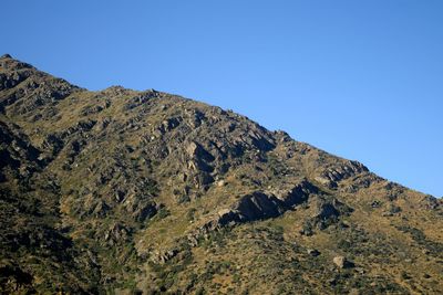 Scenic view of mountains against clear blue sky