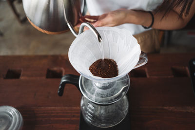 Barista dripping coffee and slow coffee wooden bar style