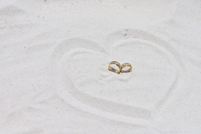 Close-up of christmas decorations on sand at beach