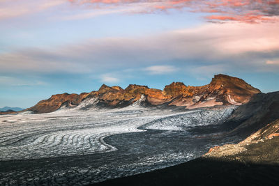 Scenic view of mountains against cloudy sky