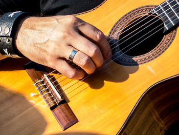 Close-up of accoustic guitar player