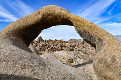 Low angle view of rock formation against sky