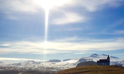 Scenic view of snow covered mountains against sky