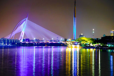 Suspension bridge over river at night