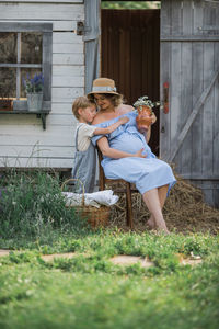 Full length of woman sitting outdoors