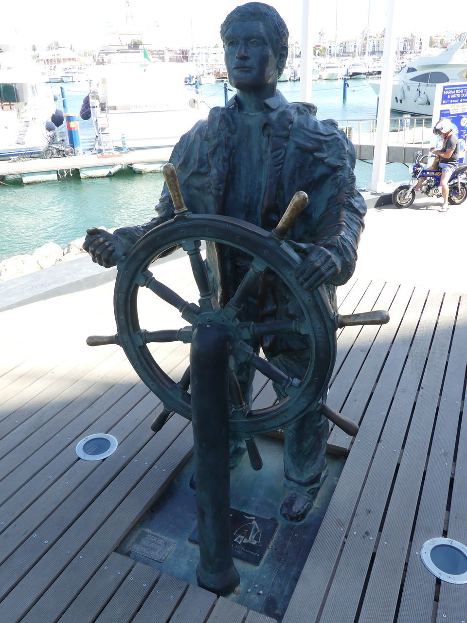 MAN STANDING ON PIER AT SEA