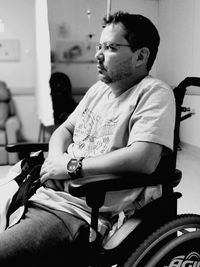 Man sitting on wheelchair at home