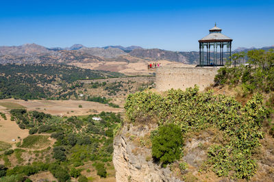 Scenic view of landscape and mountains against clear blue sky